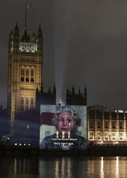 Video of survivor projected onto Houses of Parliament