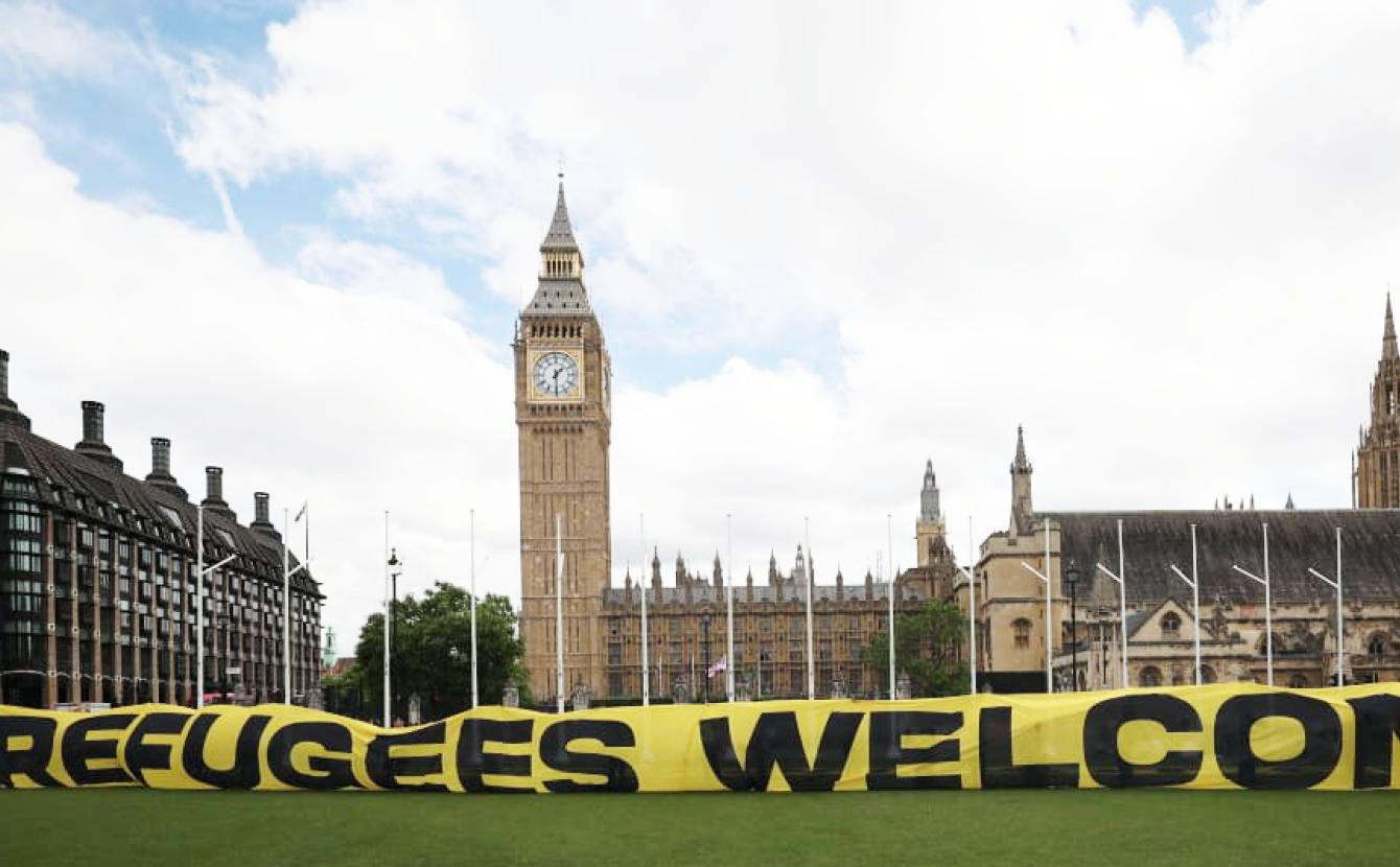 Banner on Parliament Square reading 'Refugees Welcome'
